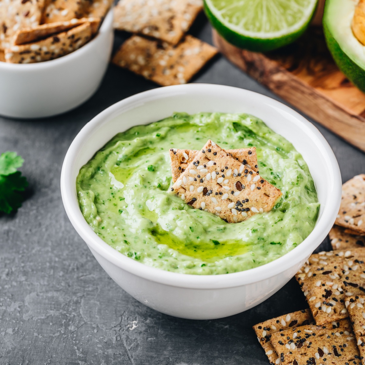 bowl of avocado dip and crackers