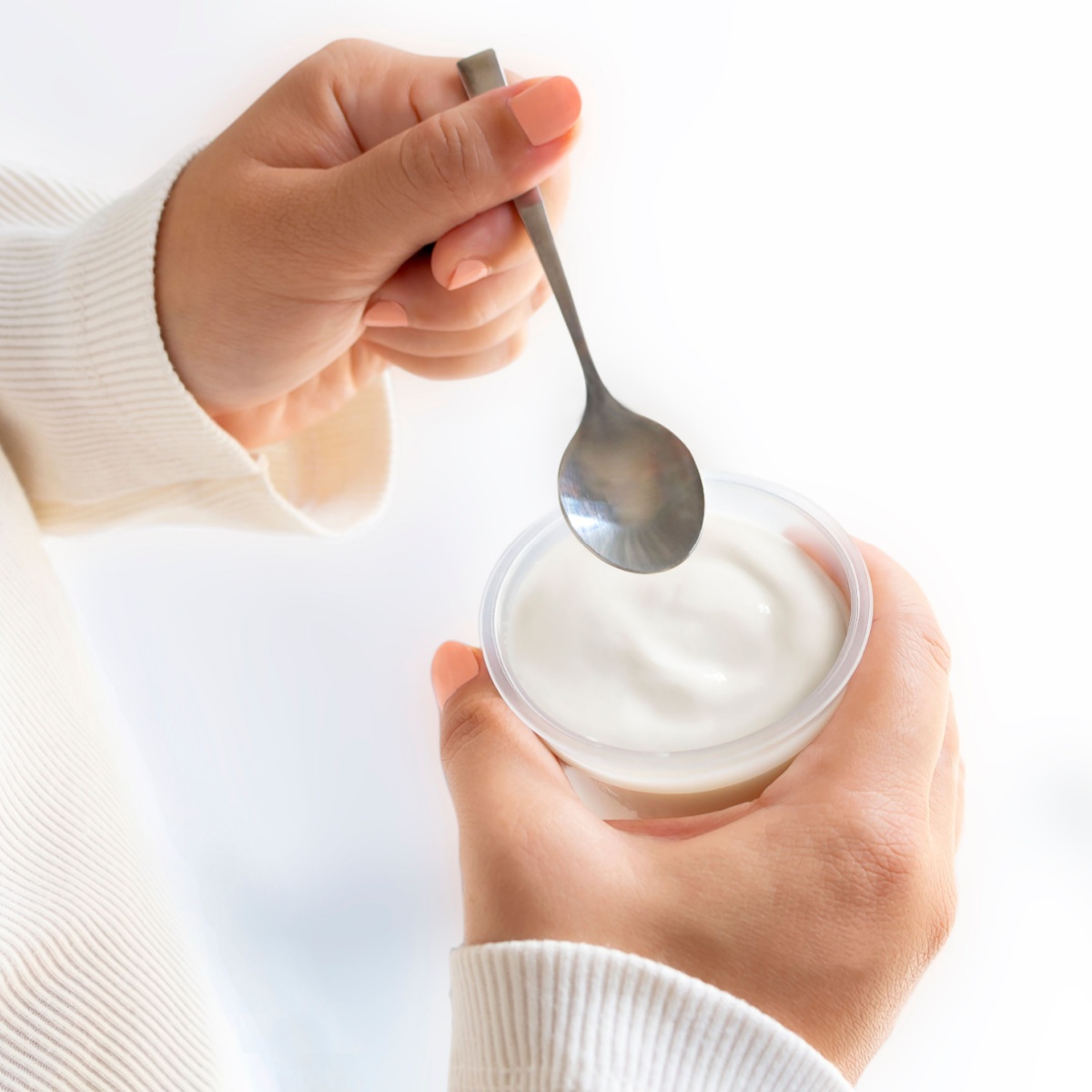 woman with yogurt cup and spoon