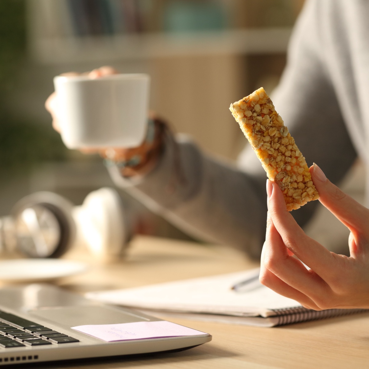 woman holding granola bar