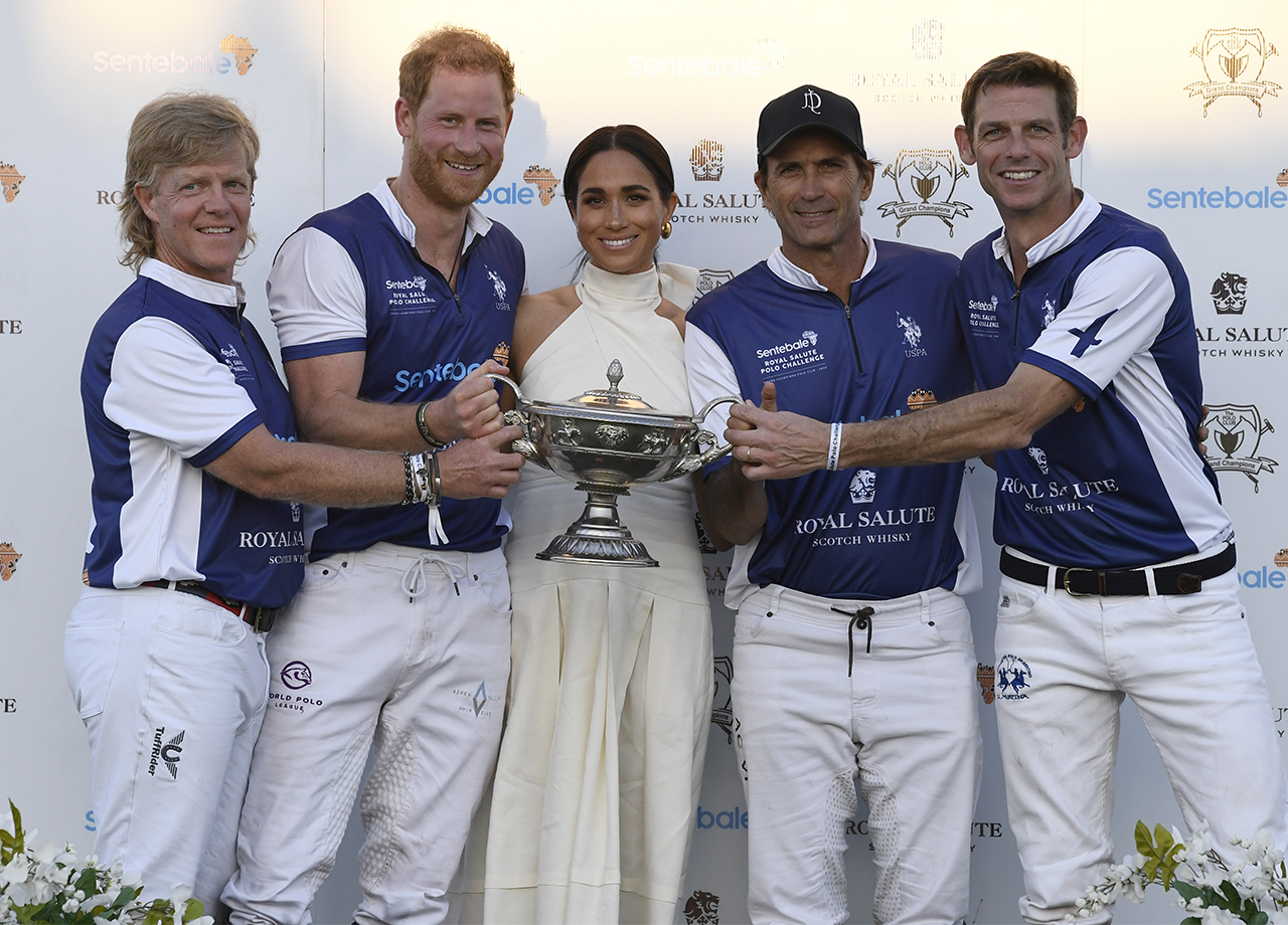 Prince Harry Meghan Markle holding trophy Royal Salute Polo Challenge benefitting Sentebale