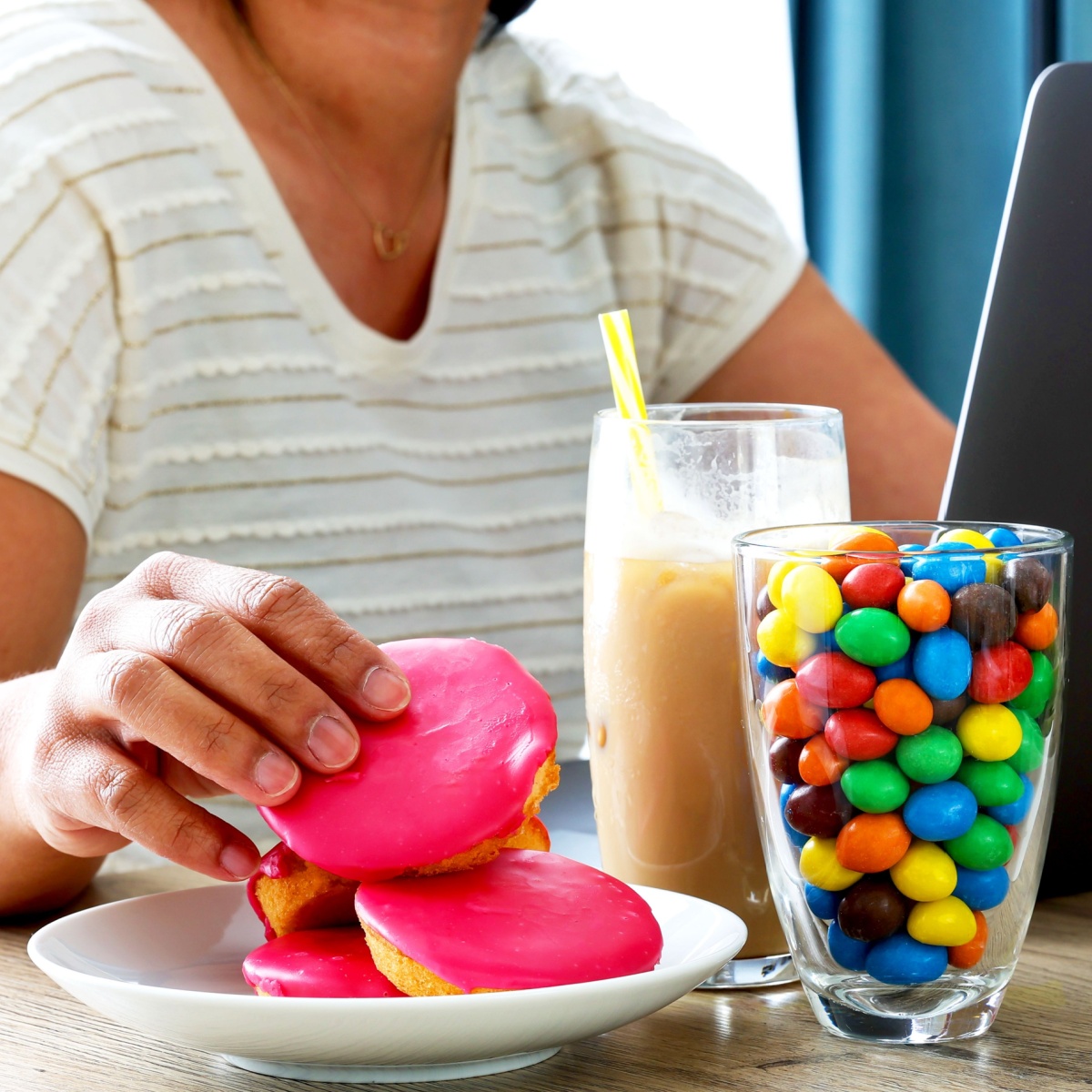 woman eating donuts at table