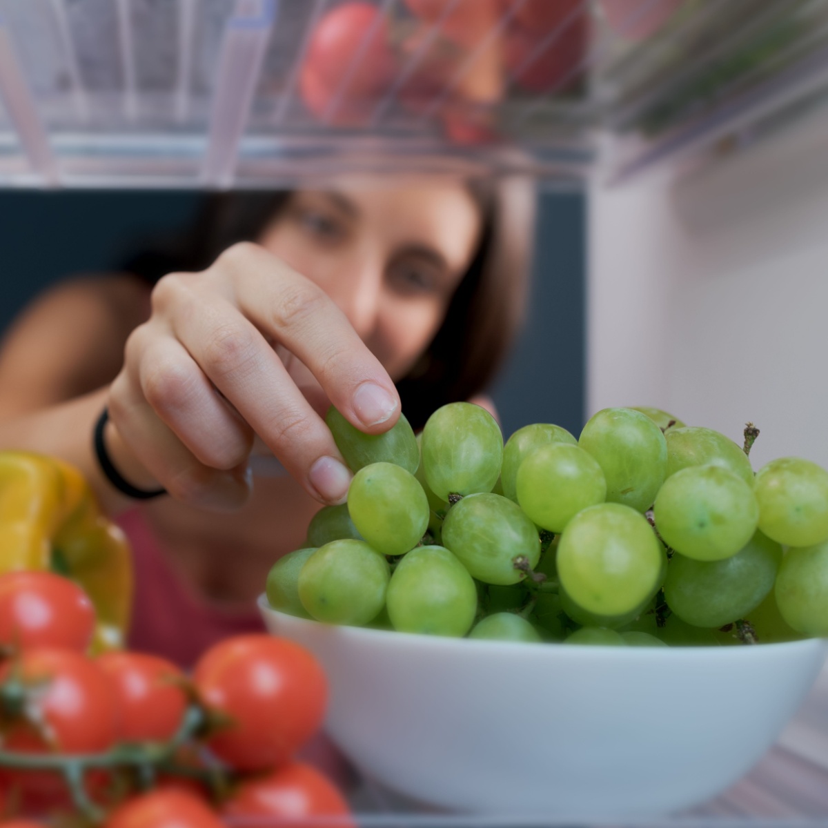 woman grabbing grapes