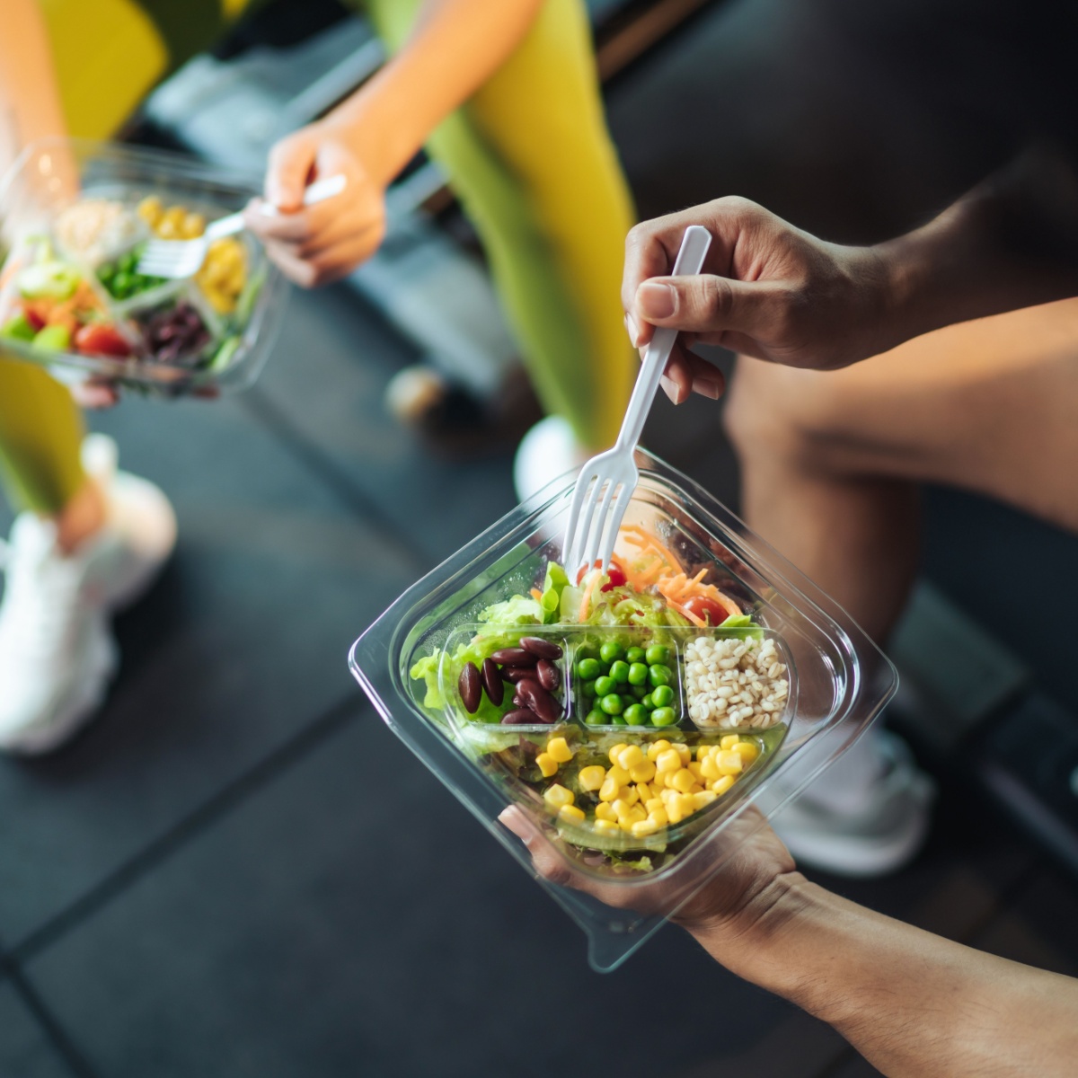 two people eating a meal at the gym