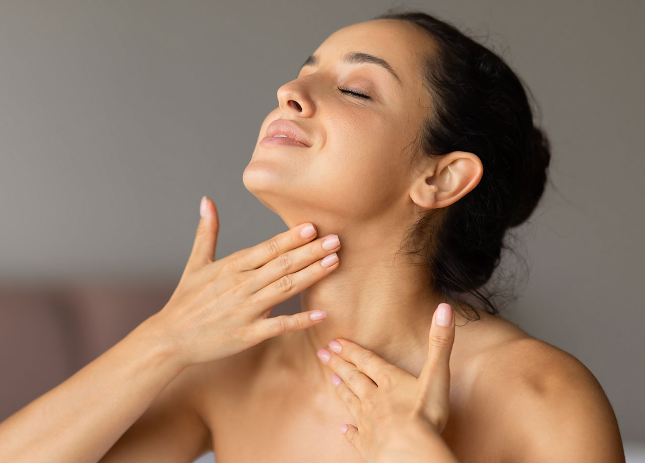 woman-applying-skincare-neck