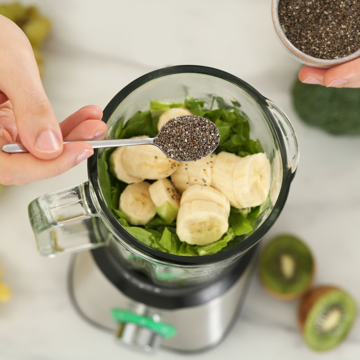 man adding chia seeds to blender