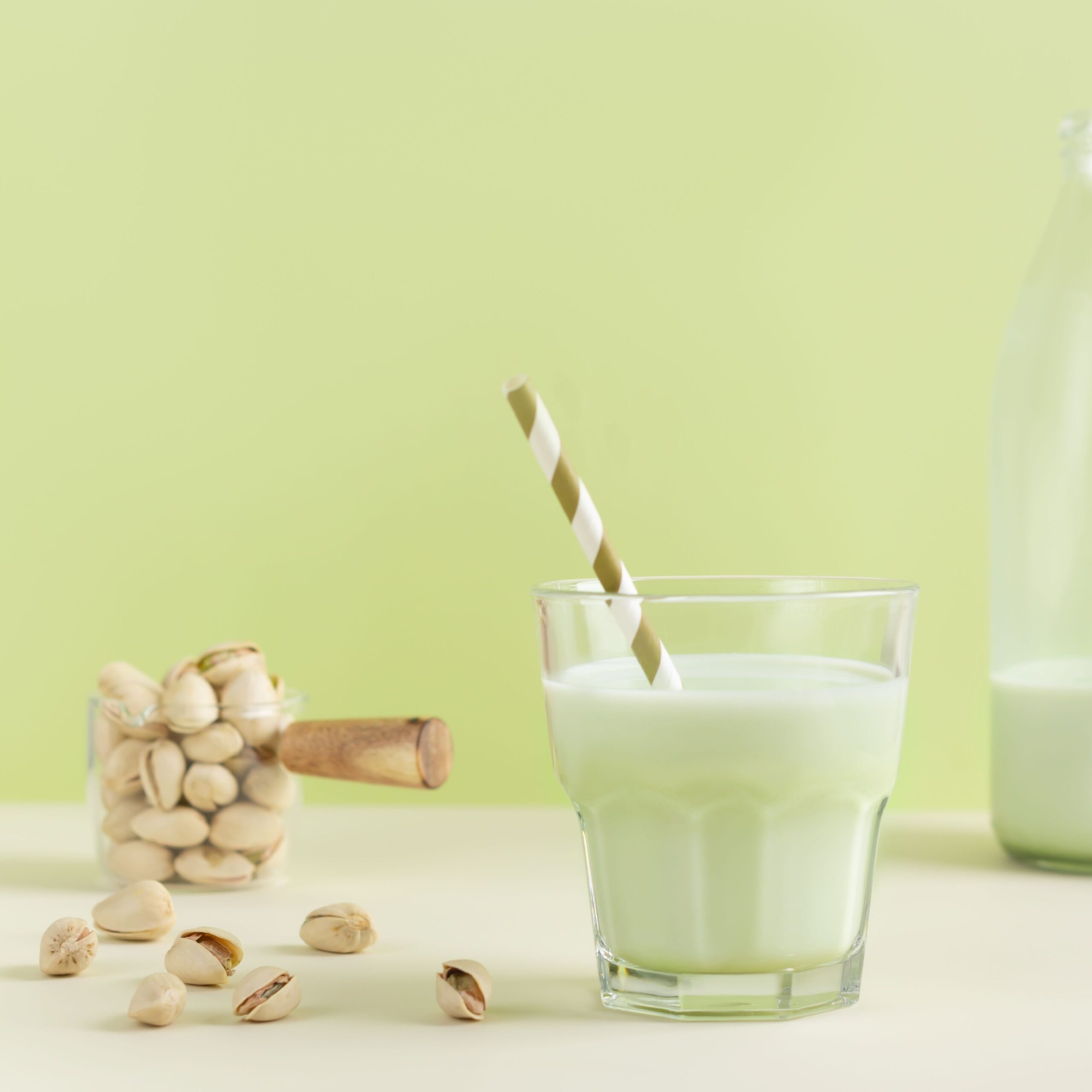 glass of pistachio milk with straw