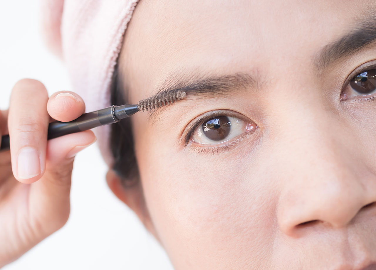 woman-brushing-eyebrows