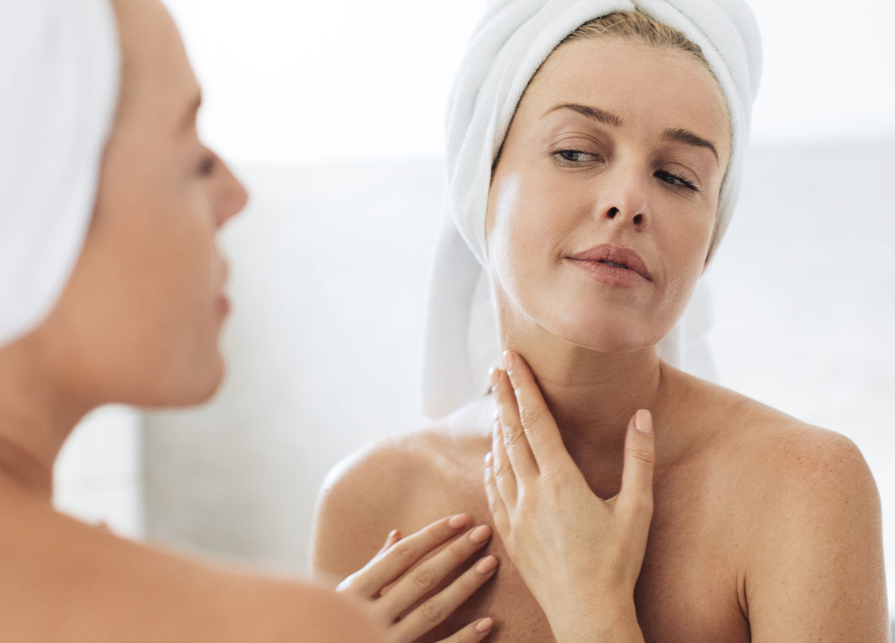 woman-applying-skincare-neck