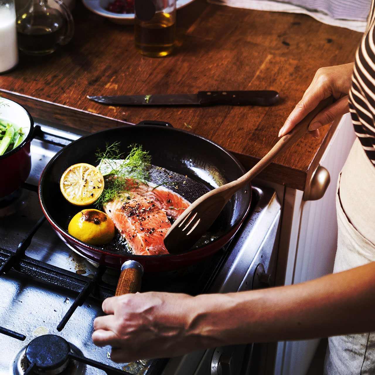 woman cooking salmon