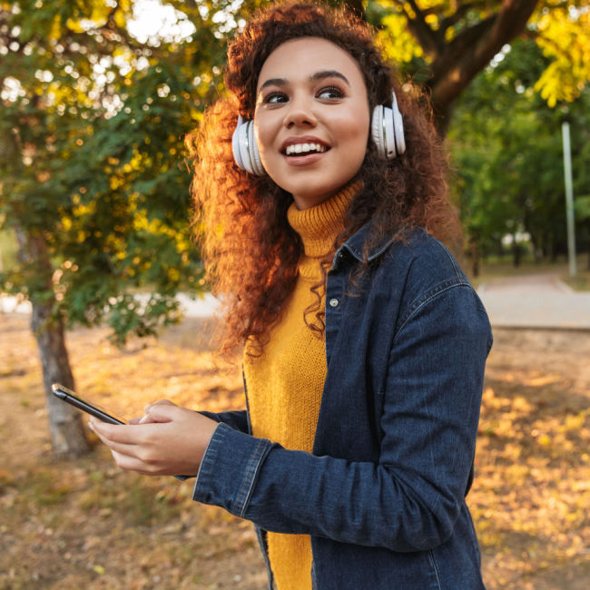 woman walking outside with headphones on