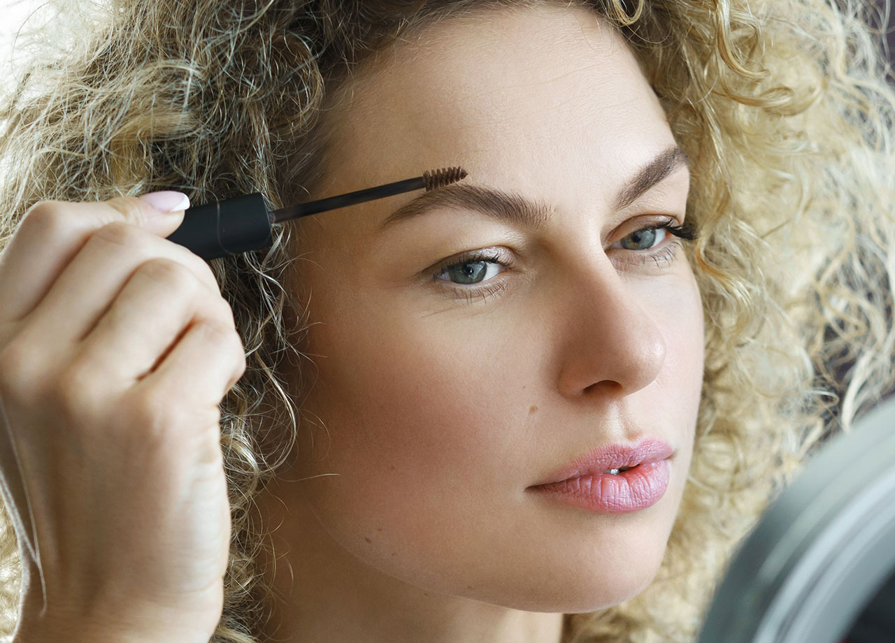 woman using eyebrow gel