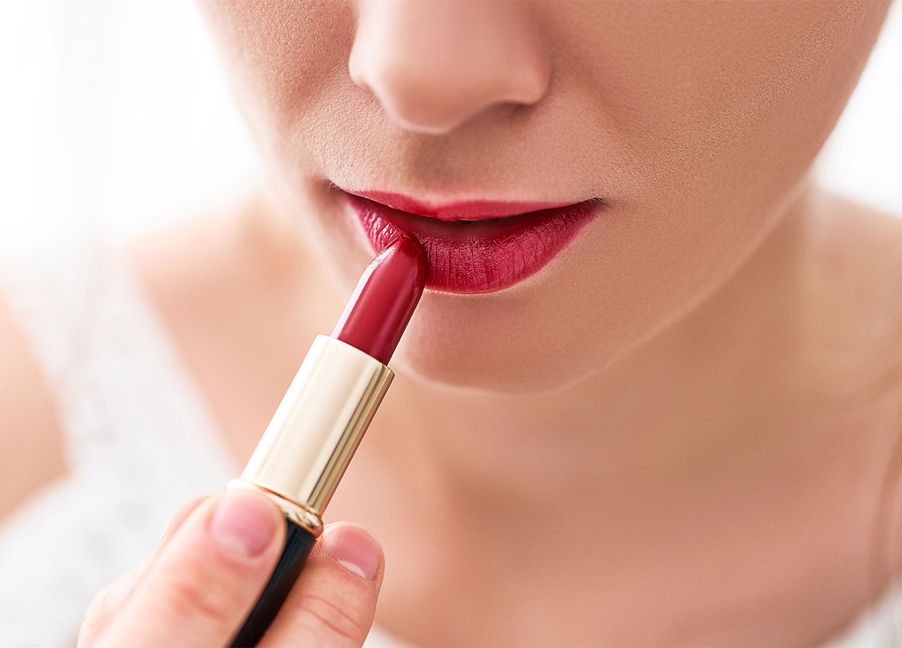 woman wearing blue based dark red lipstick