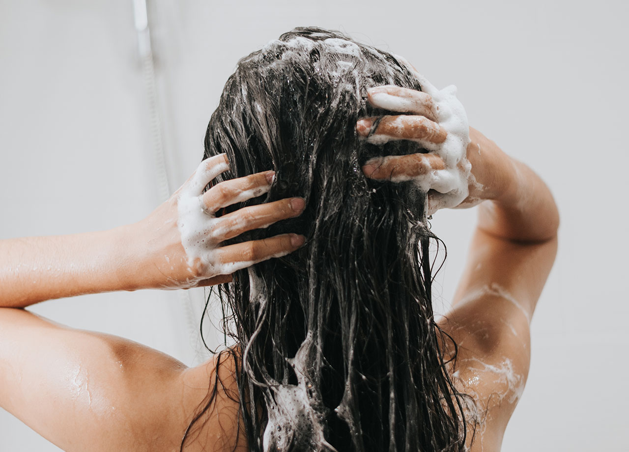 woman shampooing her hair