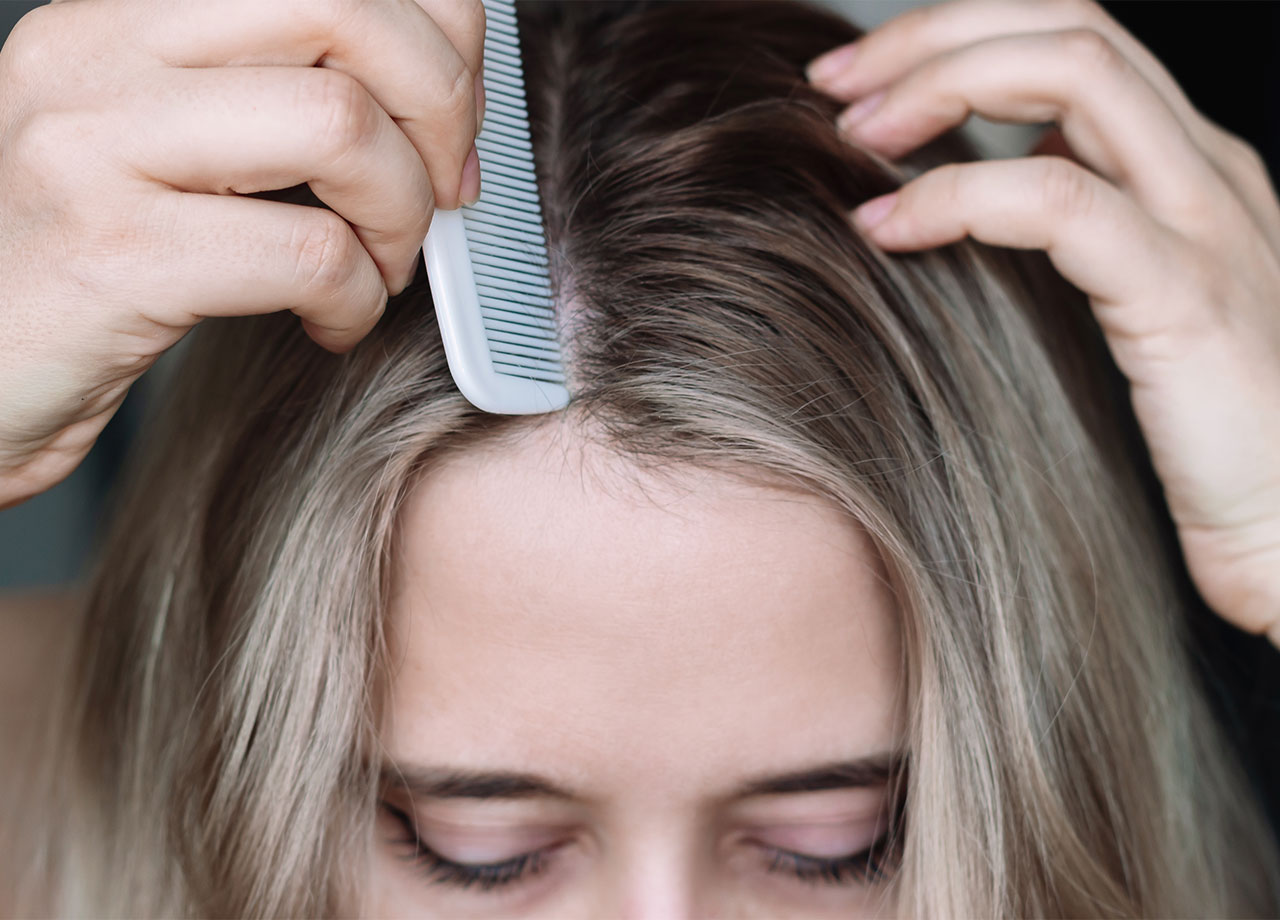 woman parting her hair in the middle