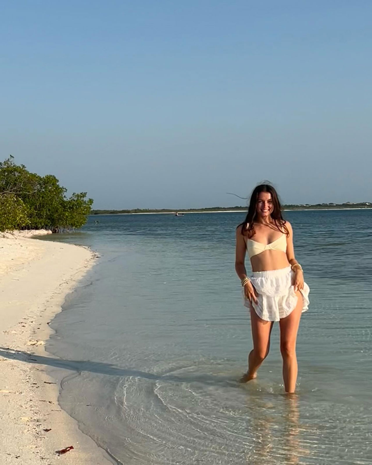 Ana de Armas on the beach in a white skirt