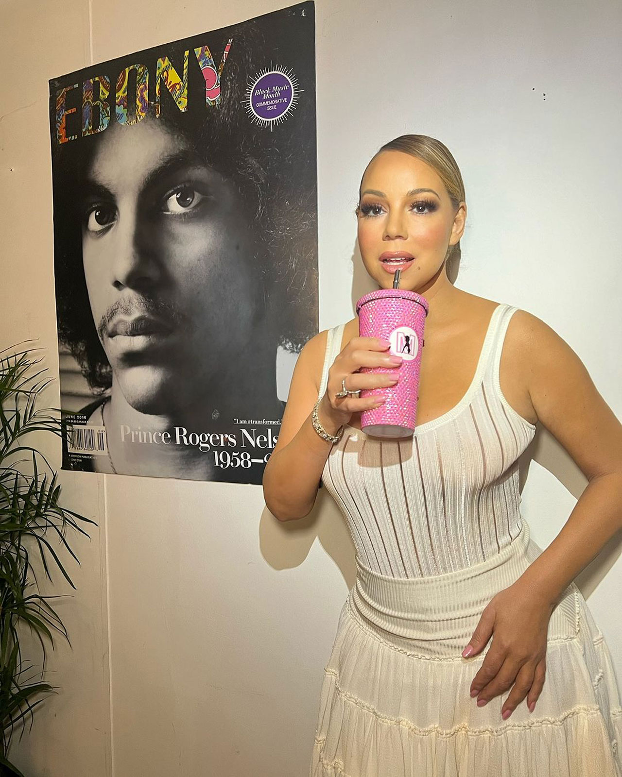 mariah carey wearing white tank top and holding pink rhinestone merch cup on instagram