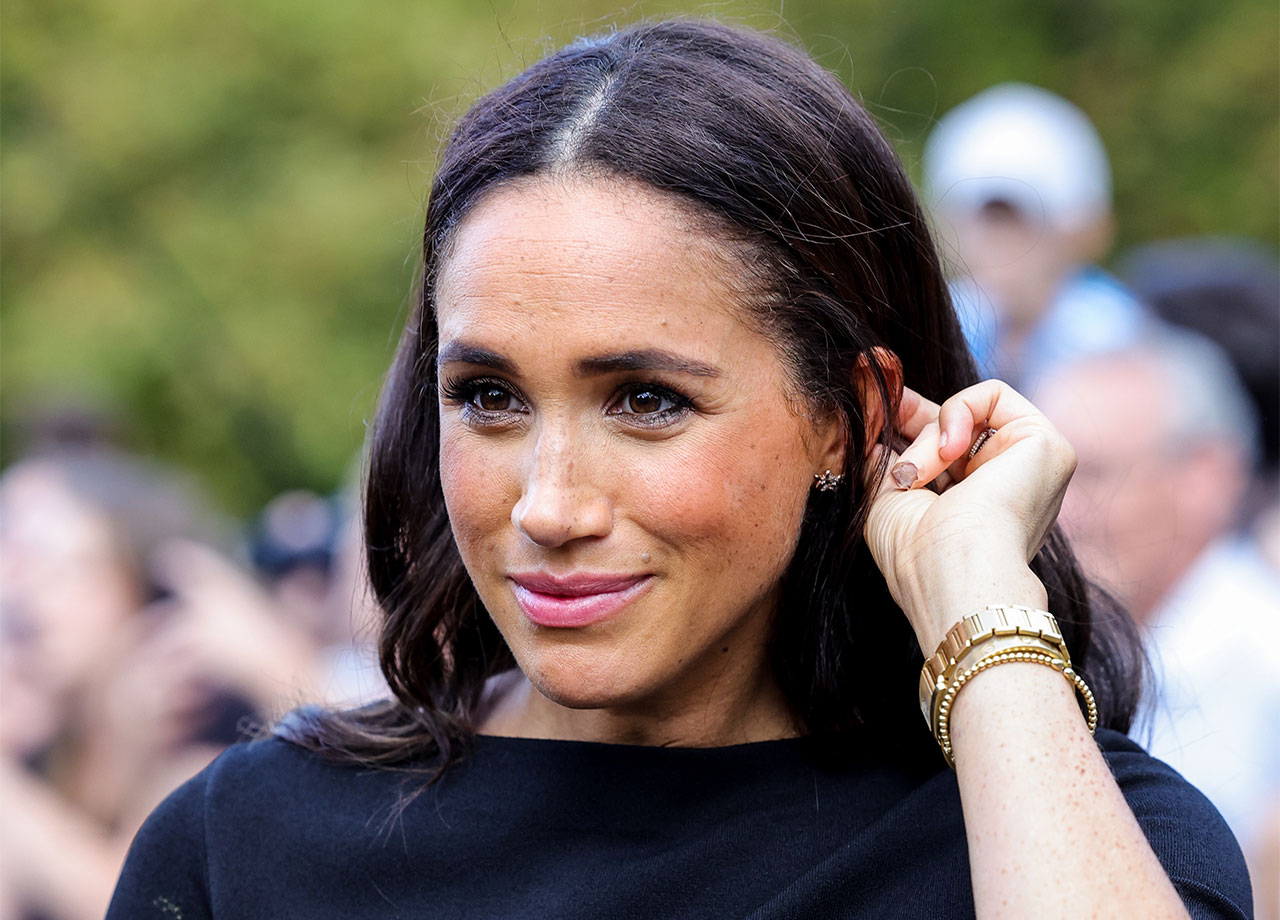 Meghan Markle looking at floral tributes Windsor Castle