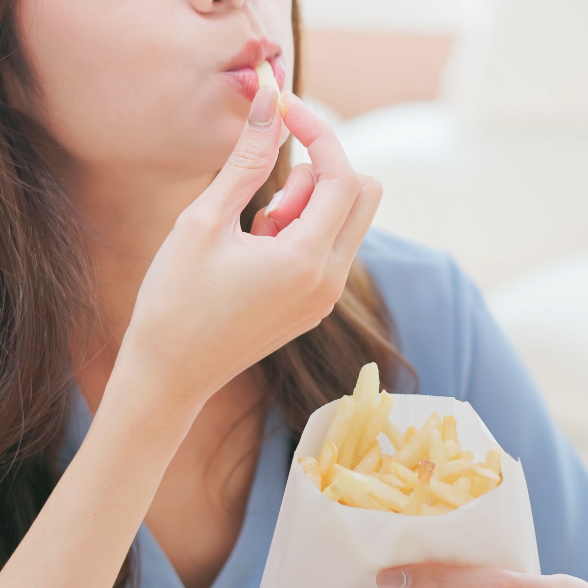 woman eating french fries