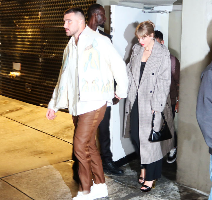 taylor swift travis kelce snl party grey coat white top brown pants