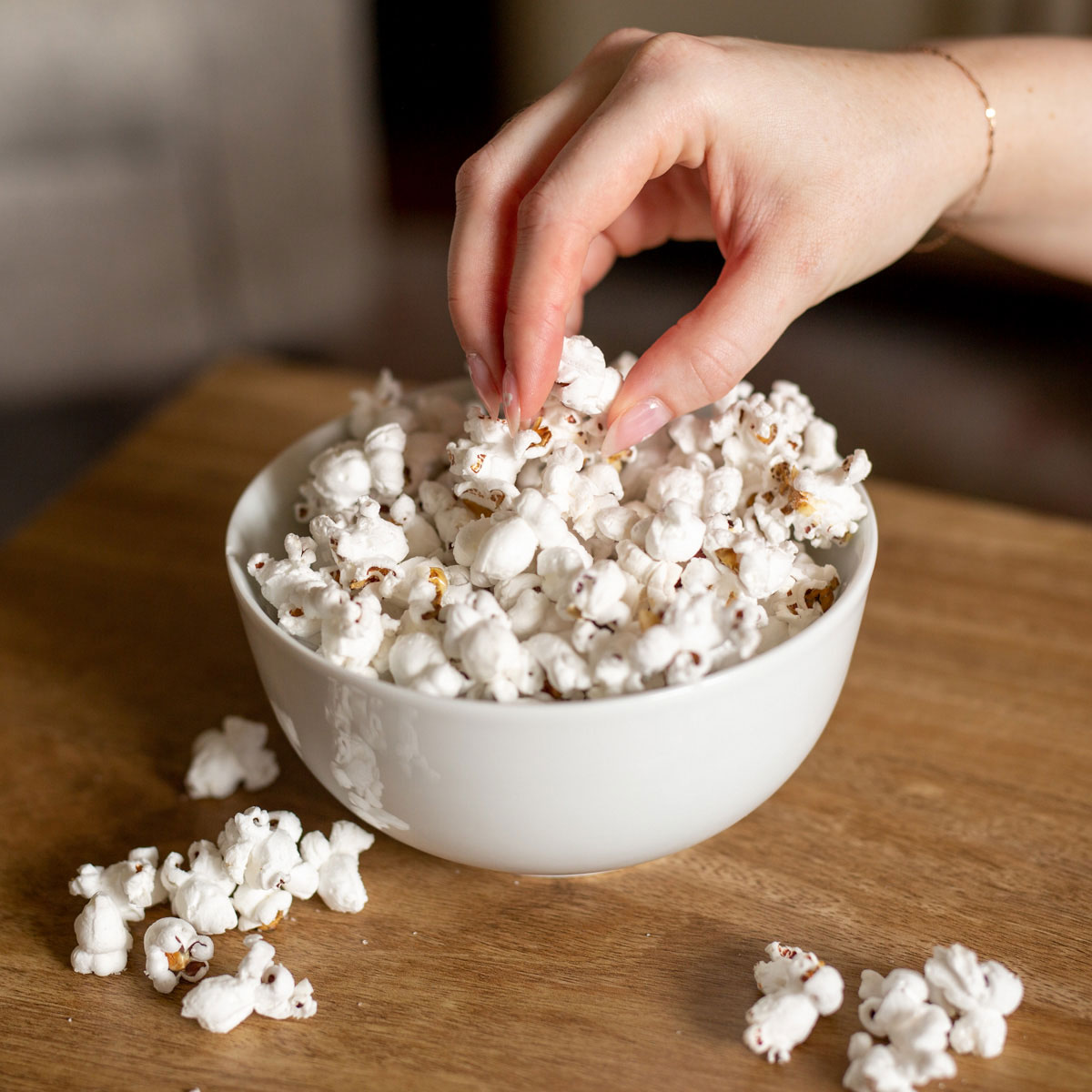 hand reaching fresh popcorn