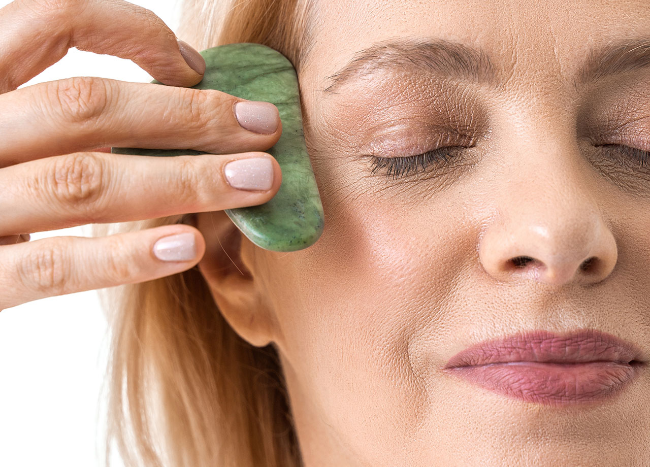 woman-using-gua-sha-stone-eyes