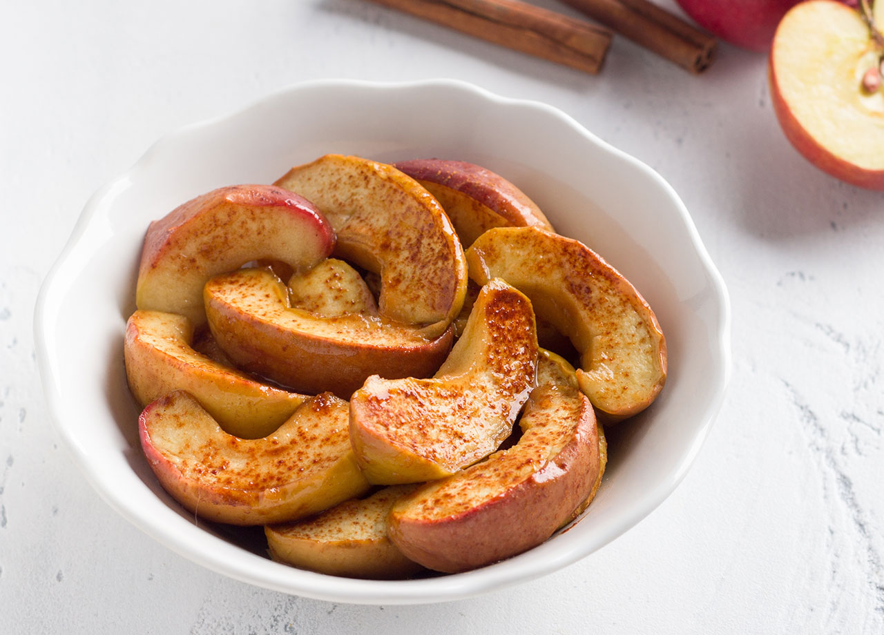 baked apples in a bowl with cinnamon