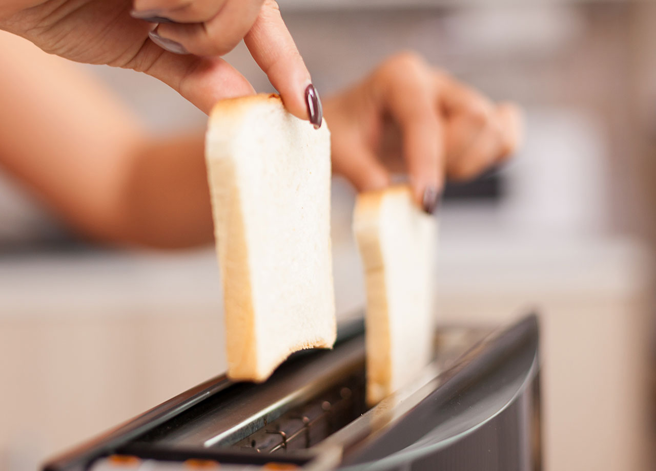 woman making white bread toast