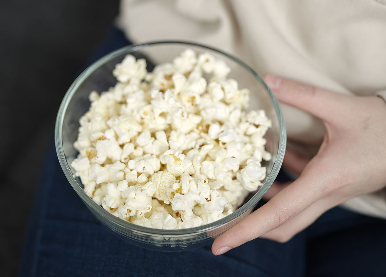 eating popcorn on the couch