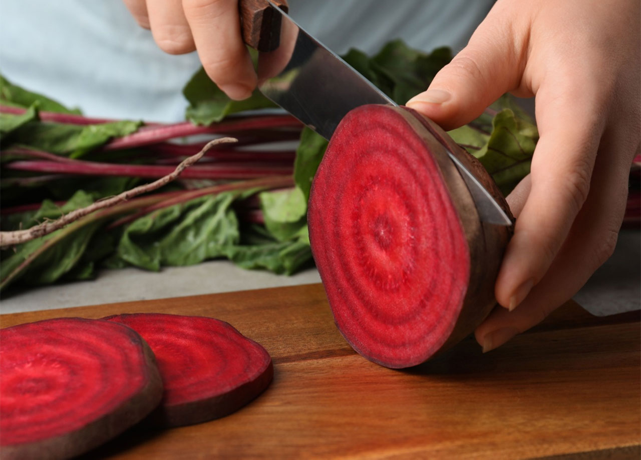 someone slicing into beets