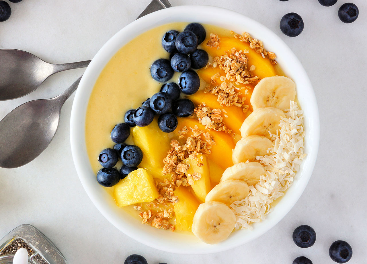 yellow smoothie bowl with fresh fruit