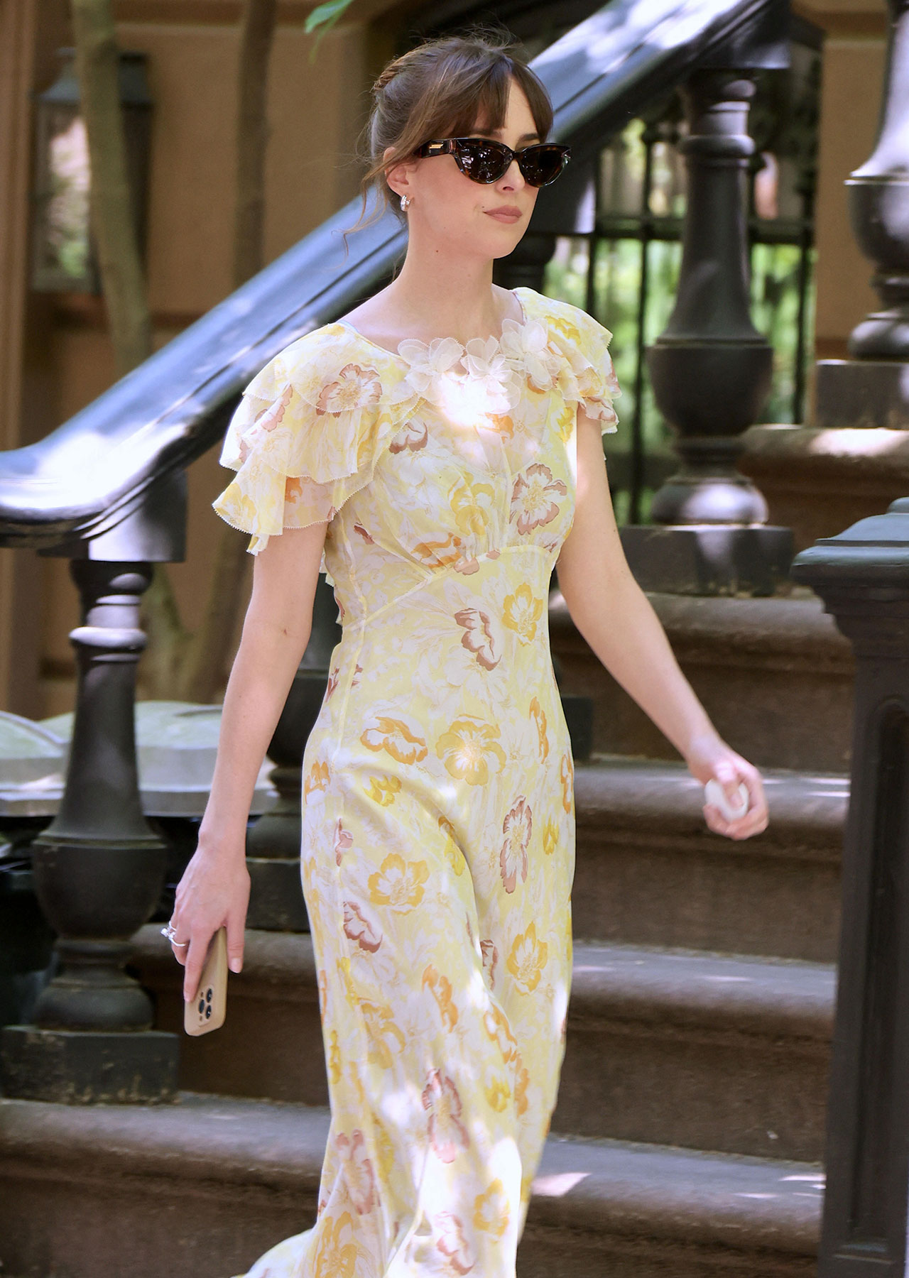 dakota johnson walks on set of rom com the materialists in yellow dress and nike sneakers