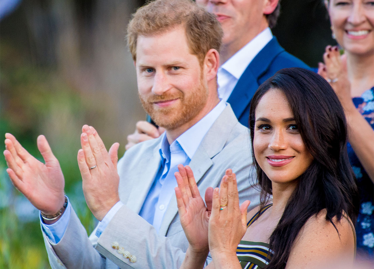 Prince Harry and Meghan Markle clapping
