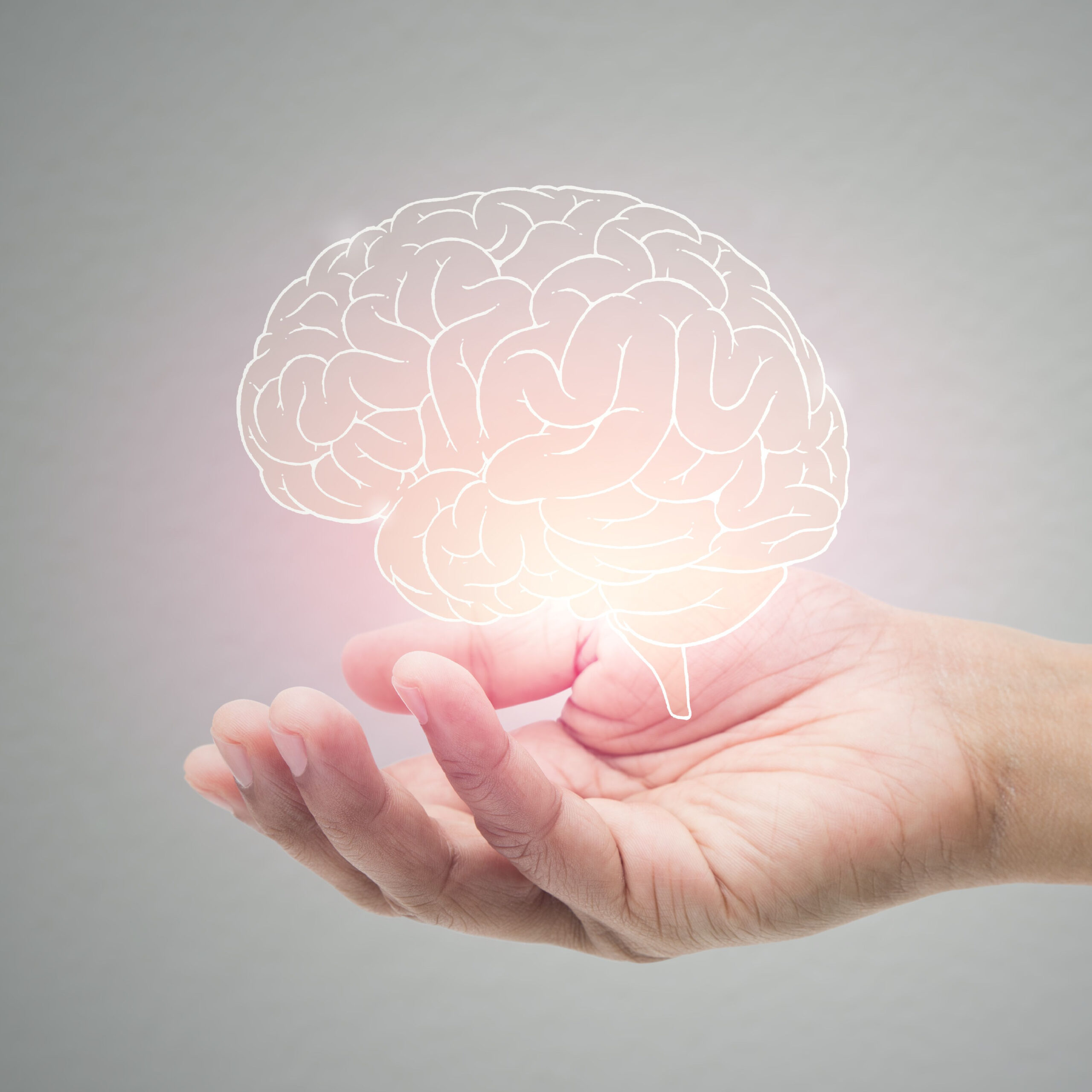 person holding glowing brain illustration