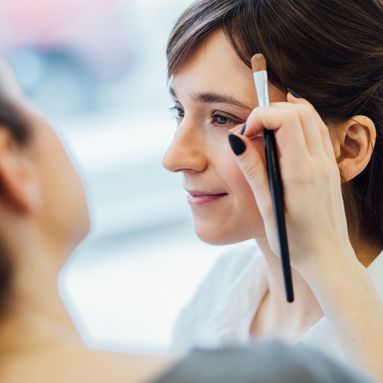 woman-getting-makeup-done