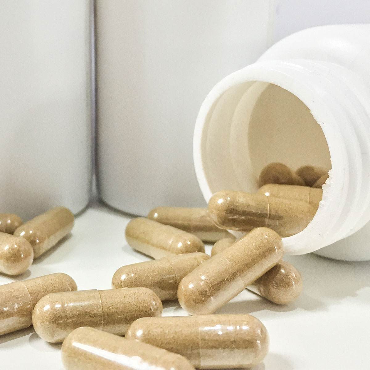 supplement capsules spilling out of jar