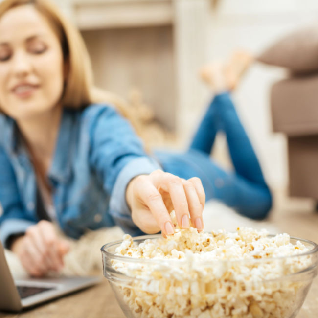 woman eating microwave popcorn