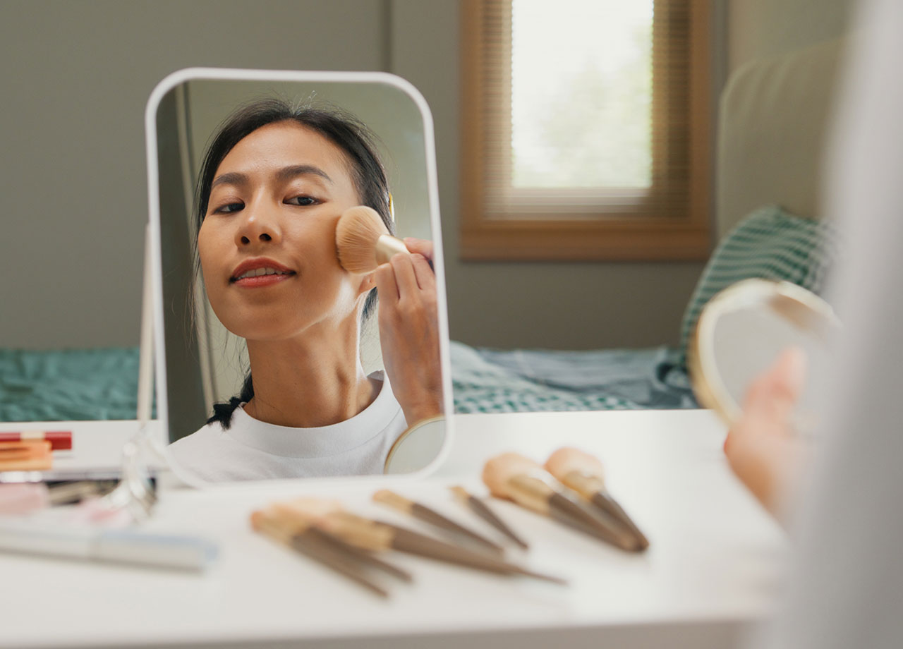 woman-applying-makeup-desk