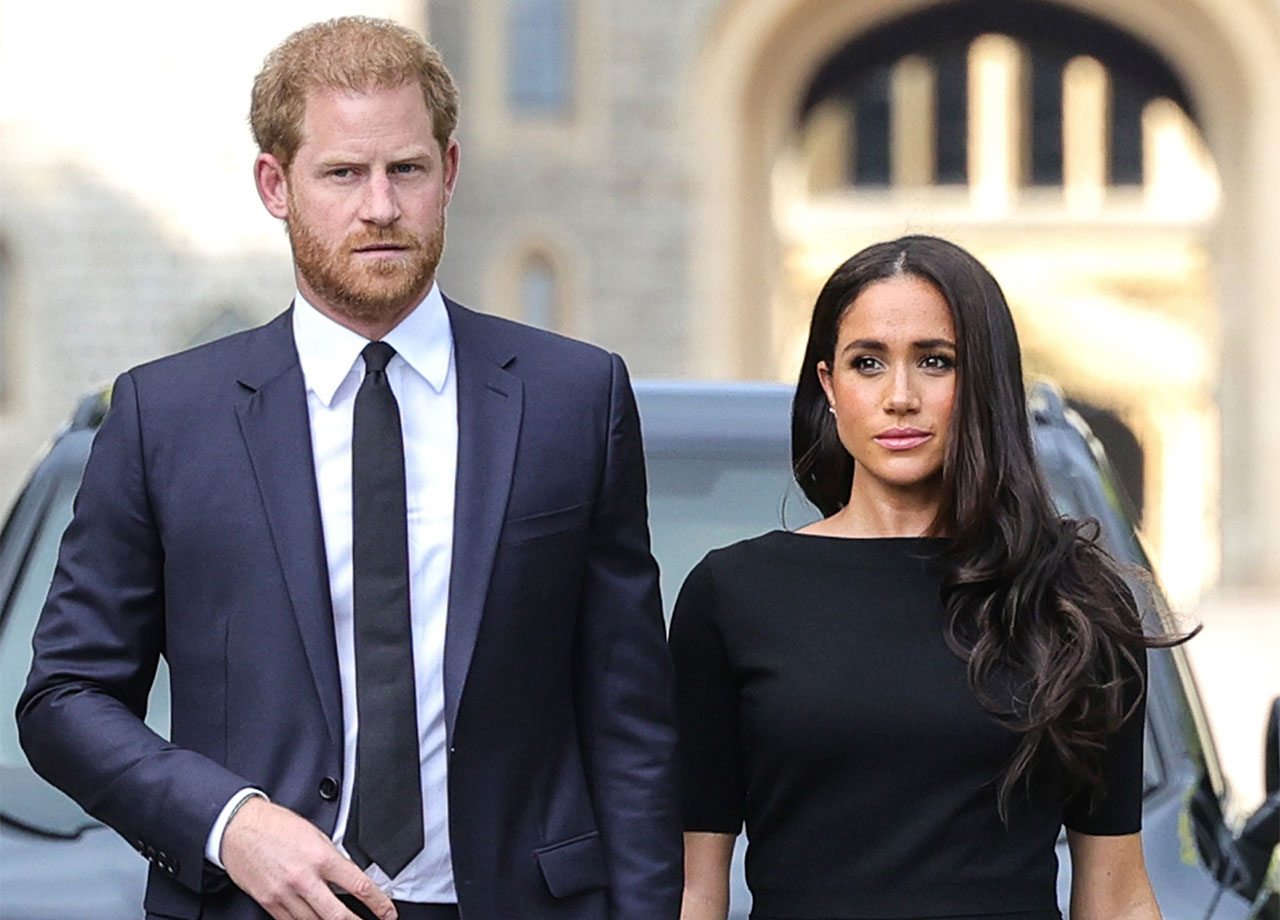 Prince Harry and Meghan Markle looking at floral tributes at Windsor Castle