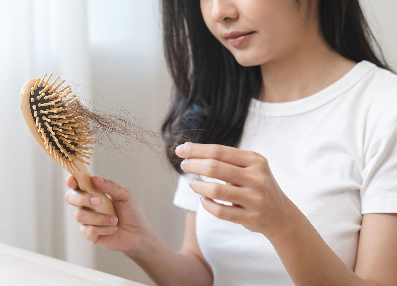 woman-pulling-hair-from-brush