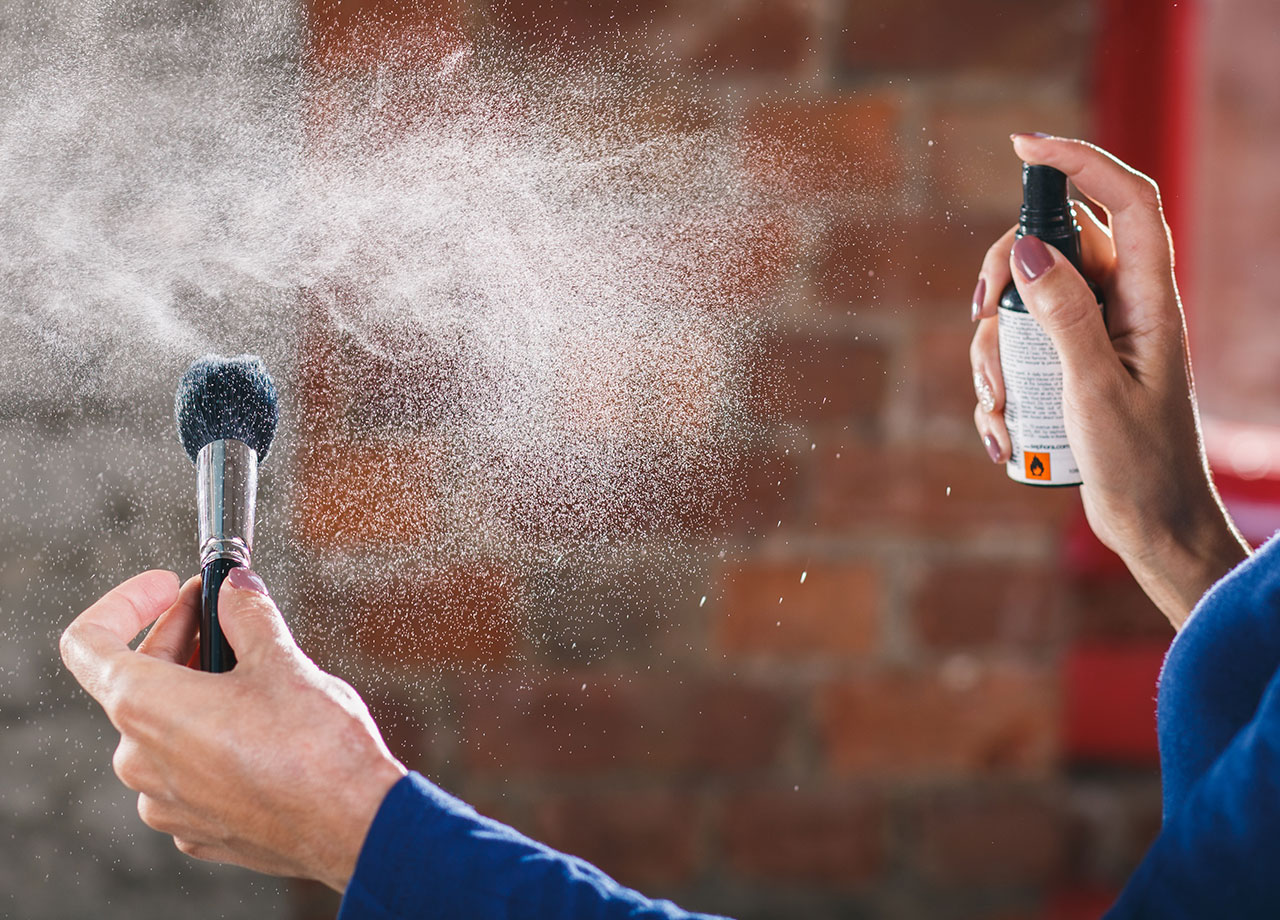 woman-applying-setting-spray-brush