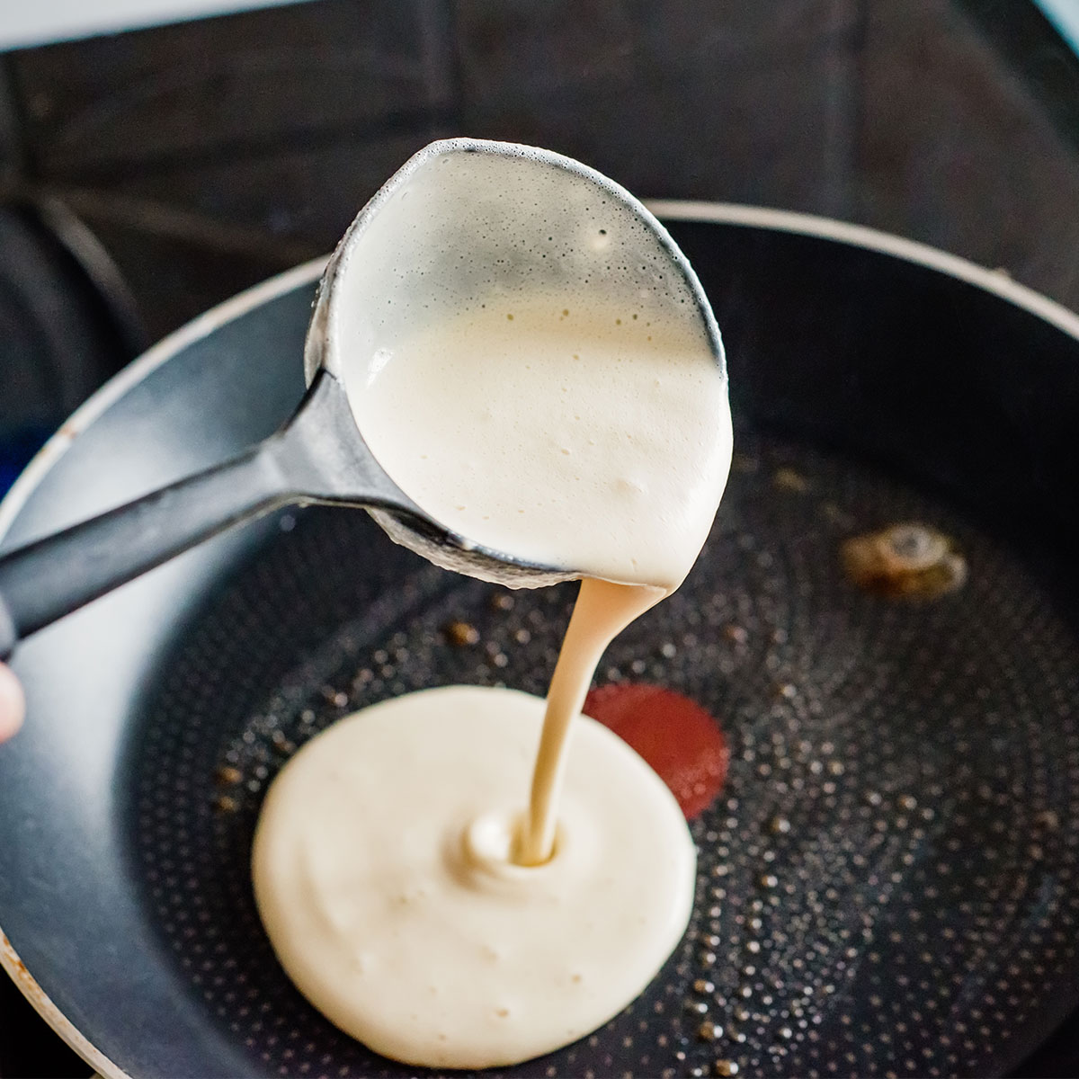 pancake batter pouring into pan