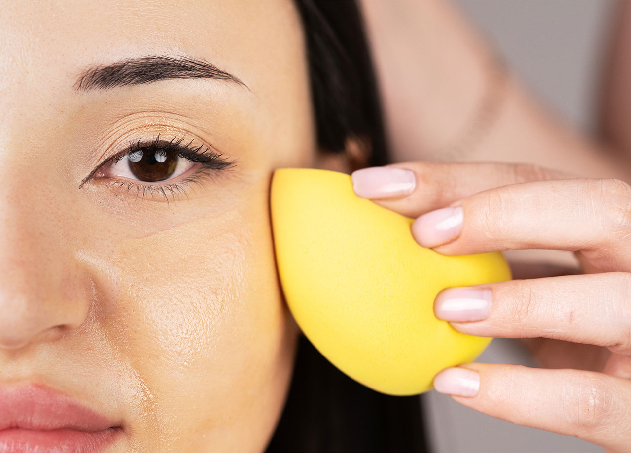 woman-applying-foundation-sponge