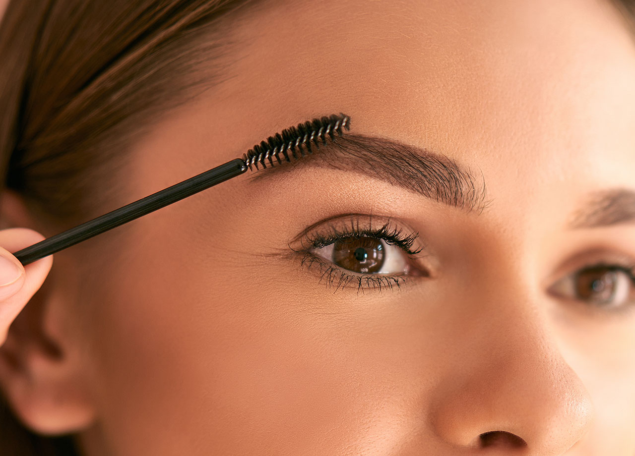 woman-brushing-eyebrows