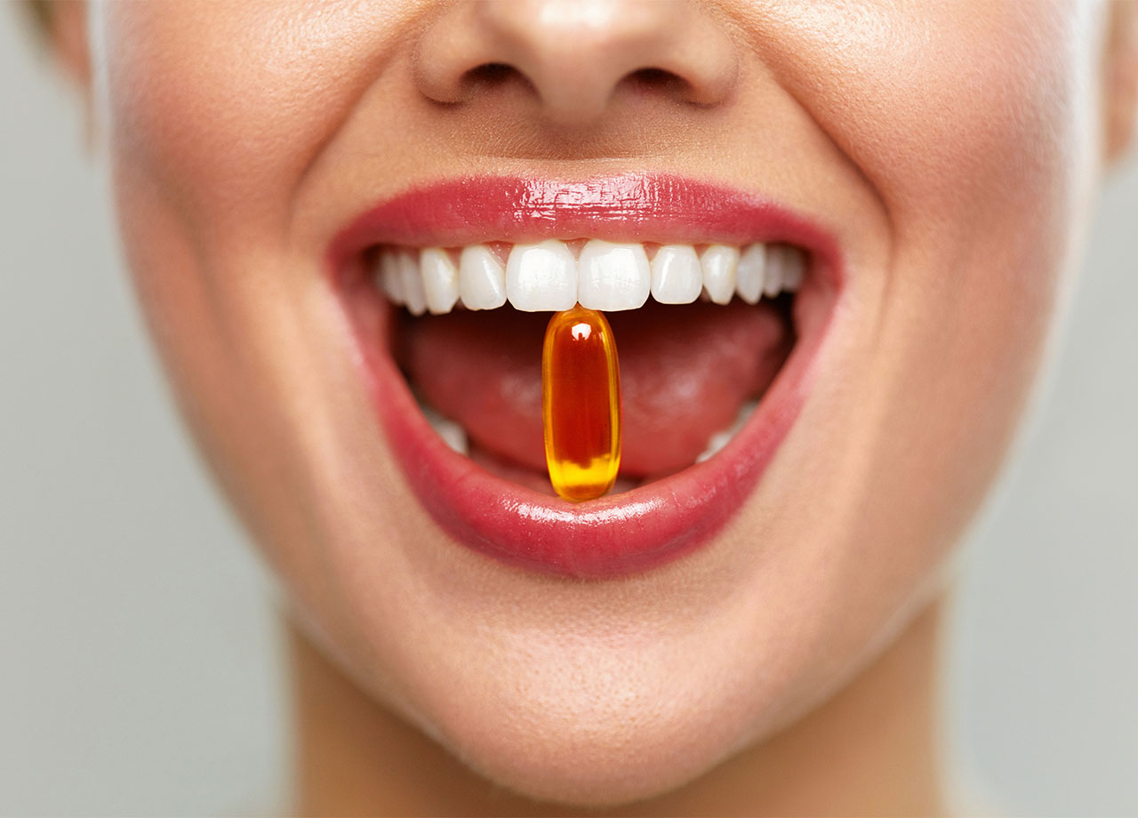 woman-holding-supplement-mouth