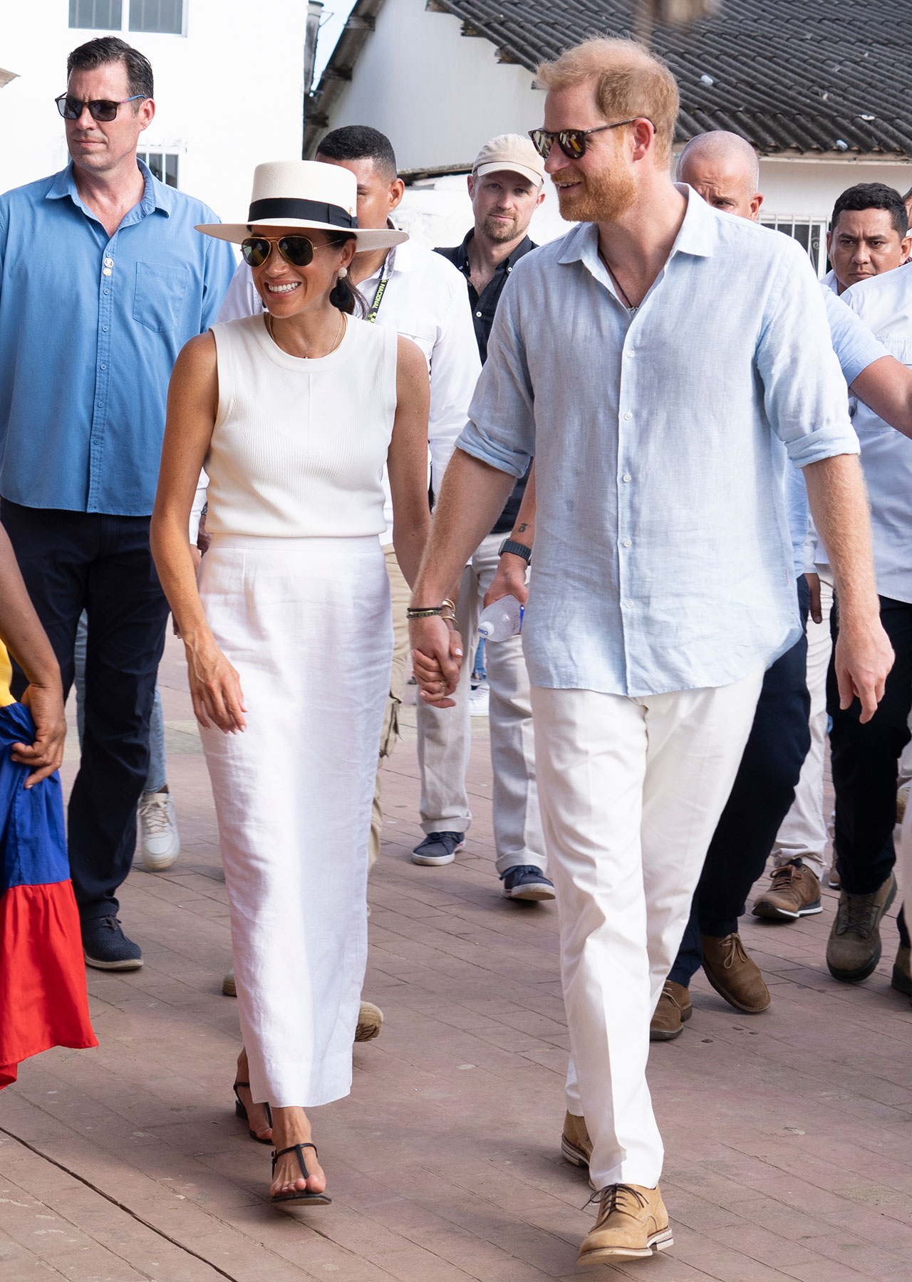 Prince Harry and Meghan Markle wearing a white outfit in Colombia