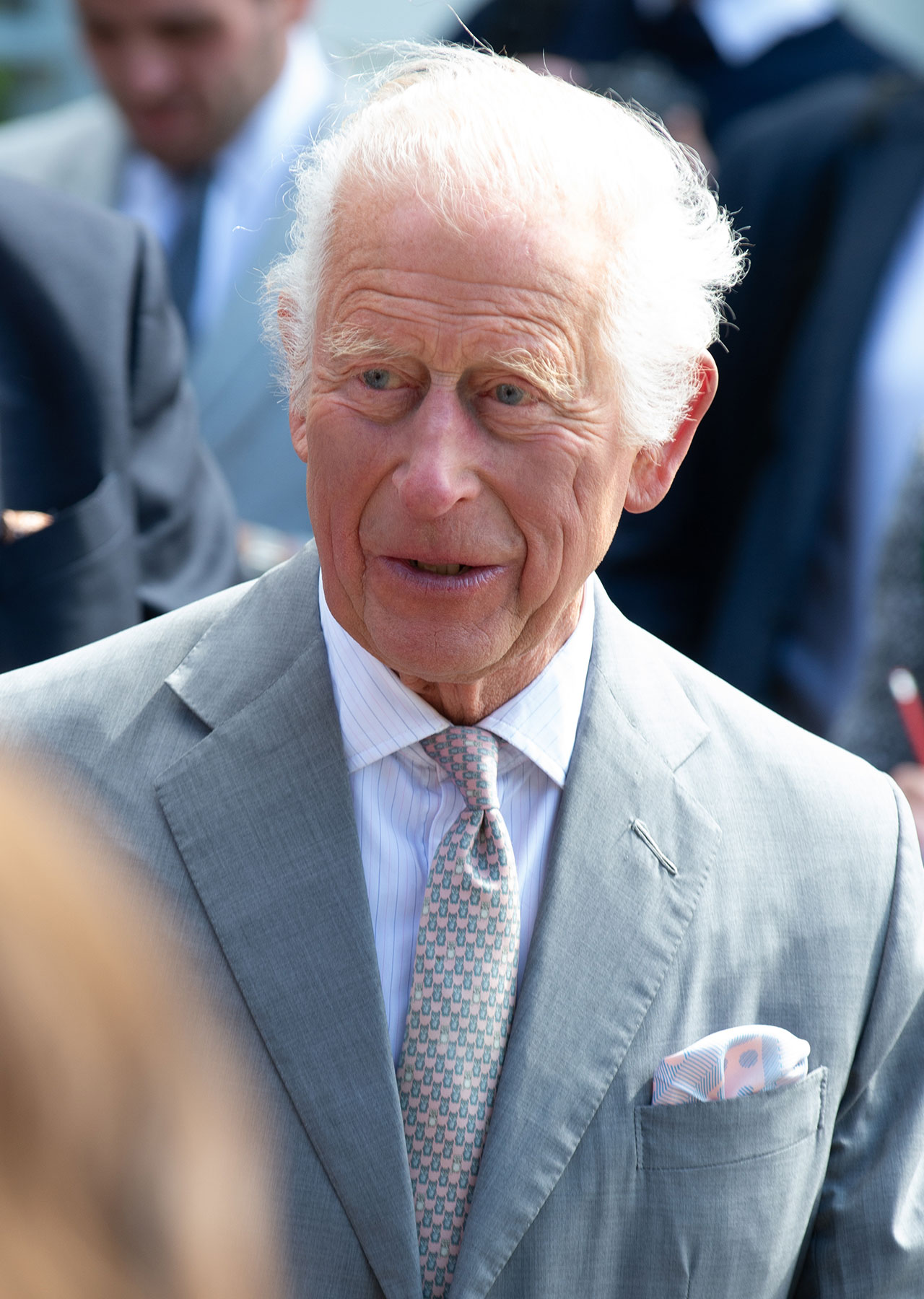 King Charles grey suit not smiling