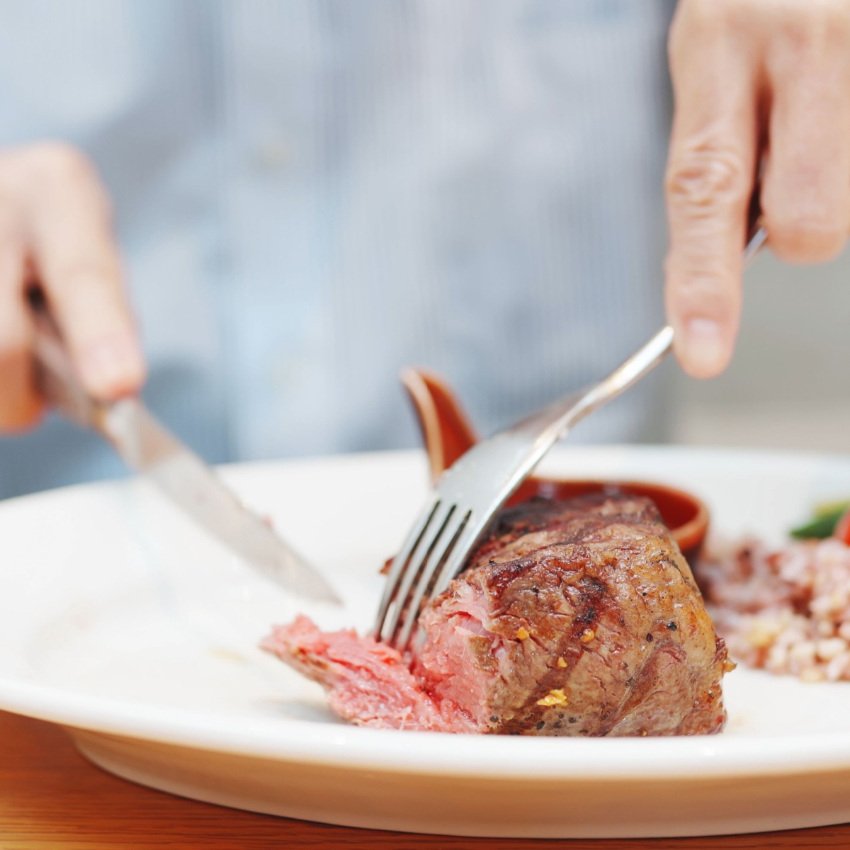 man eating piece of meat