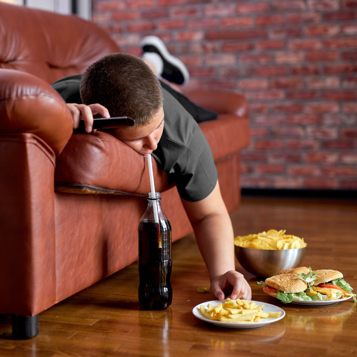 lazy boy drinking soda on couch