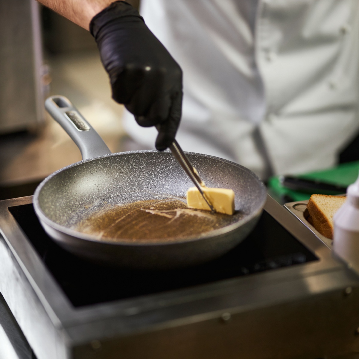 man greasing pan with butter