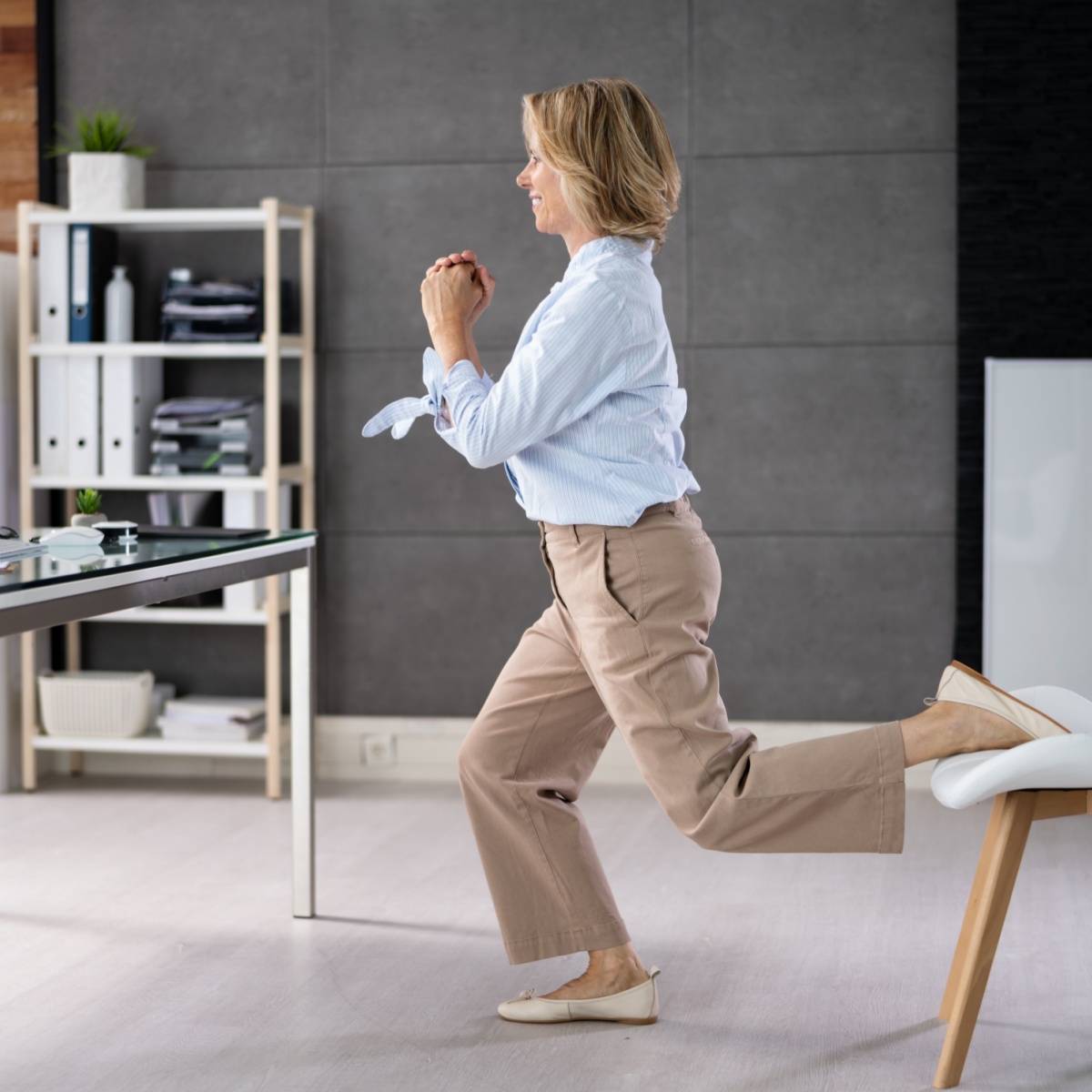 woman at office doing bulgarian split squats